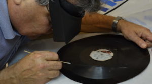 Conservator examines record
